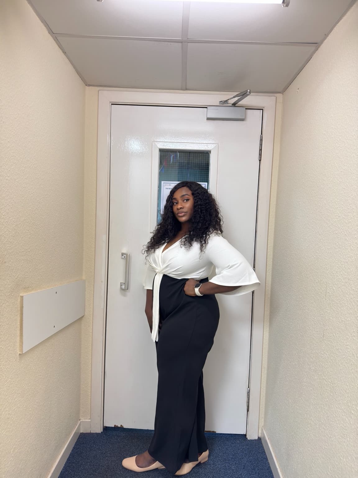 Imalue Nnabuchi in a professional black and white outfit